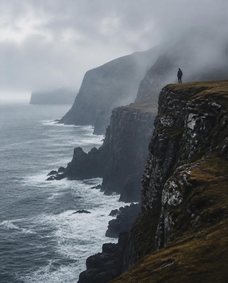 Misty coastal cliffs above a grey sea